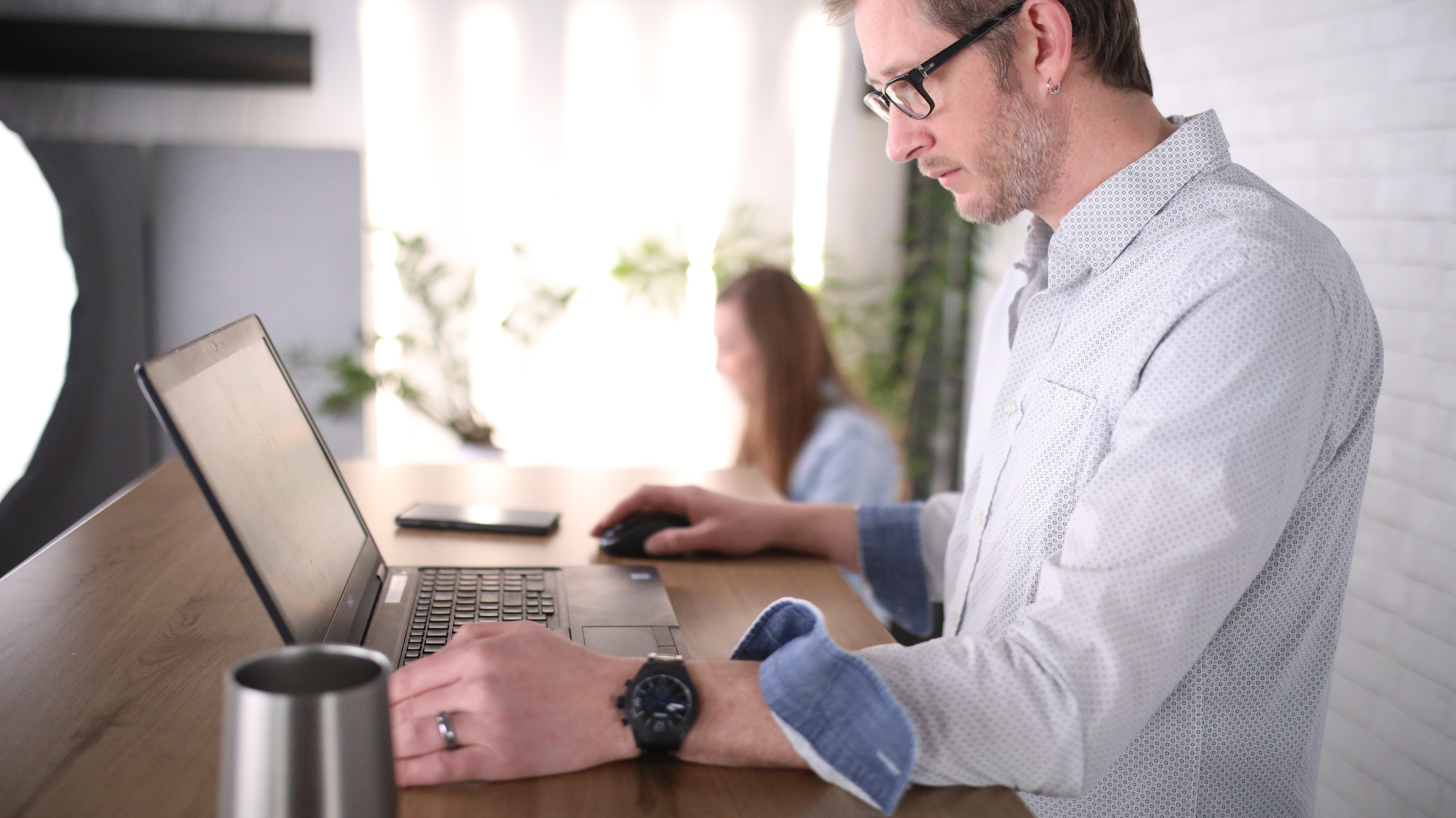 man in white dress shirt using computer